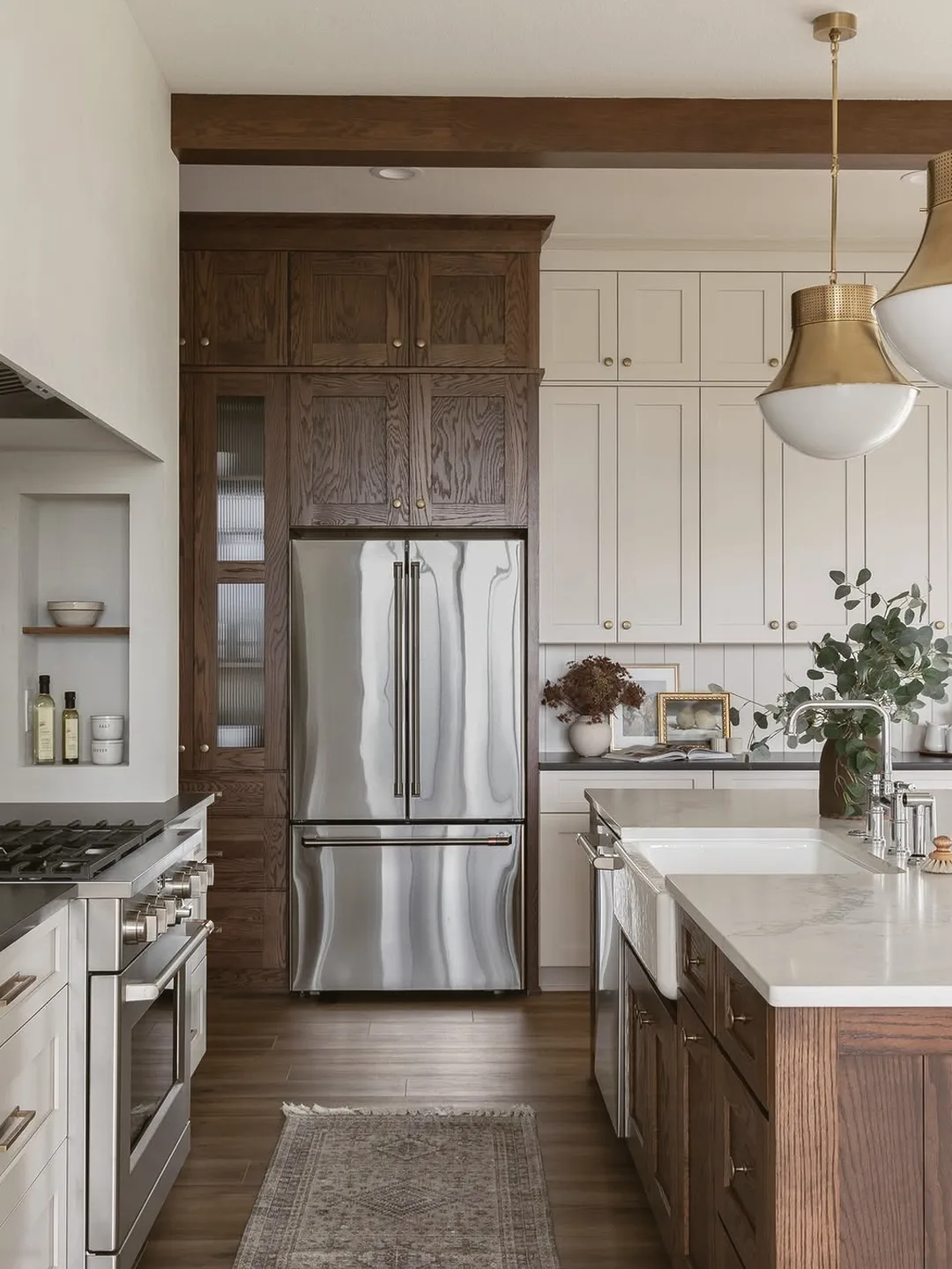 Kitchen interior with dark wood cabinetry and brass pendant lighting
